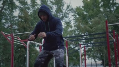 Antrenman sırasında çömelme hareketleri yapan erkek sporcu