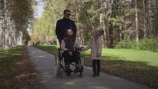 Family with disabled mother, father and daughter spending time together — Stock Video