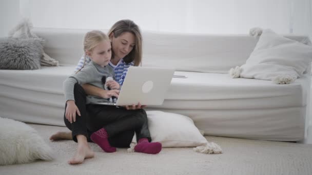 Woman working from home with child — Stock Video