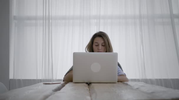 Kvinna frilansare använder sin bärbara dator hemma — Stockvideo