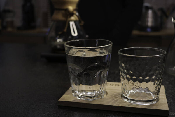 A glass cup of water to drink coffee, empty glasses of water. Pure water