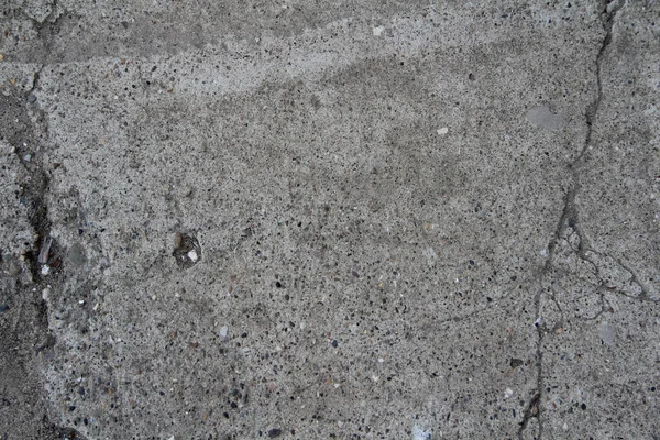 A stone surface with cracks, spots, irregularities. — Stock Photo, Image