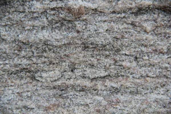 Een stenen oppervlak met scheuren, vlekken, onregelmatigheden. — Stockfoto