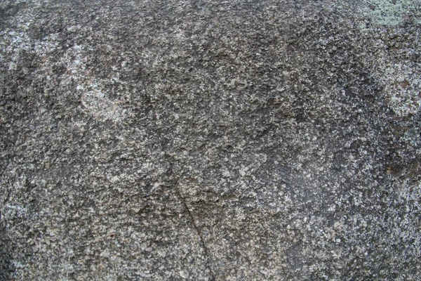 A stone surface with cracks, spots, irregularities. — Stock Photo, Image