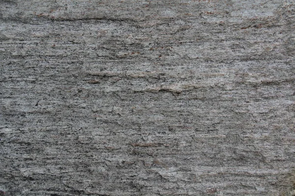 Uma superfície de pedra com rachaduras, manchas, irregularidades. — Fotografia de Stock
