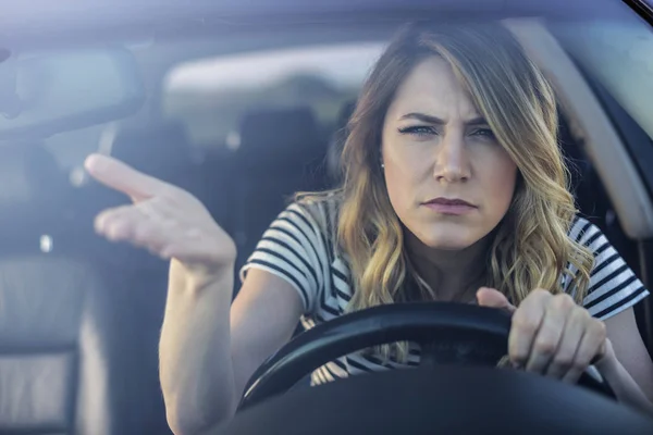Mujer enojada conduciendo un coche . — Foto de Stock