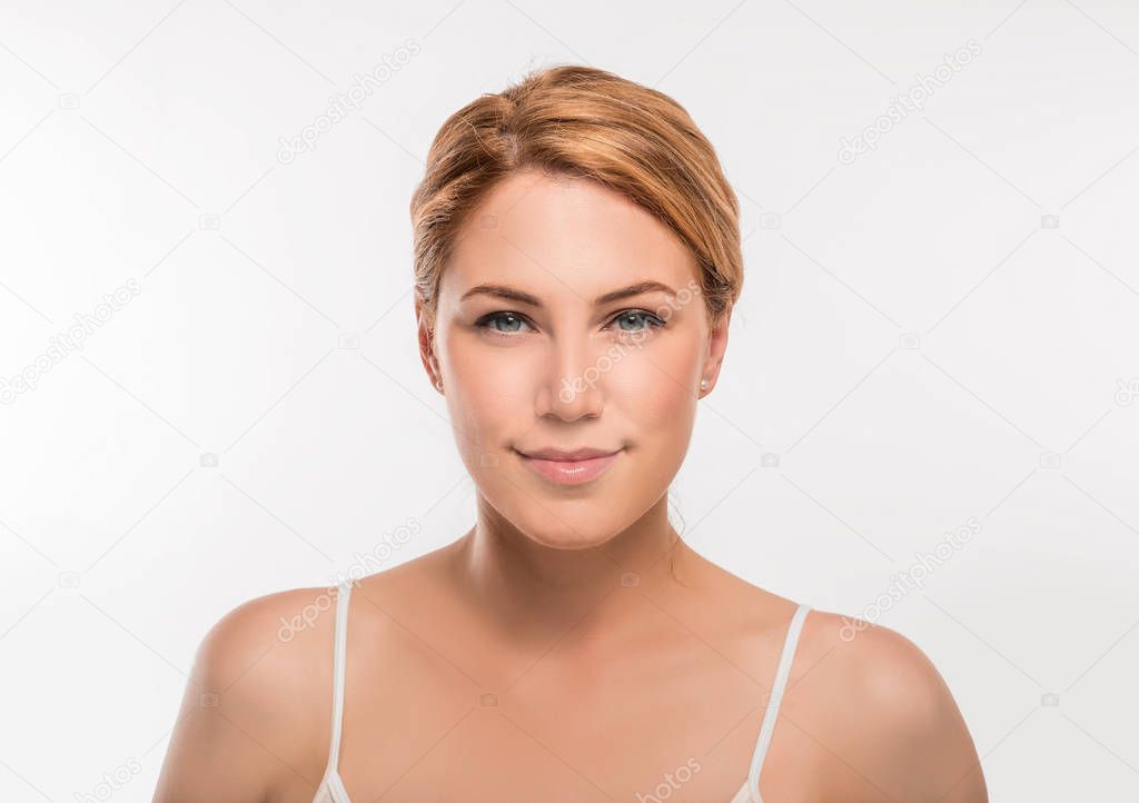 Beauty Woman face Portrait. Blonde female looking at camera on a white background.