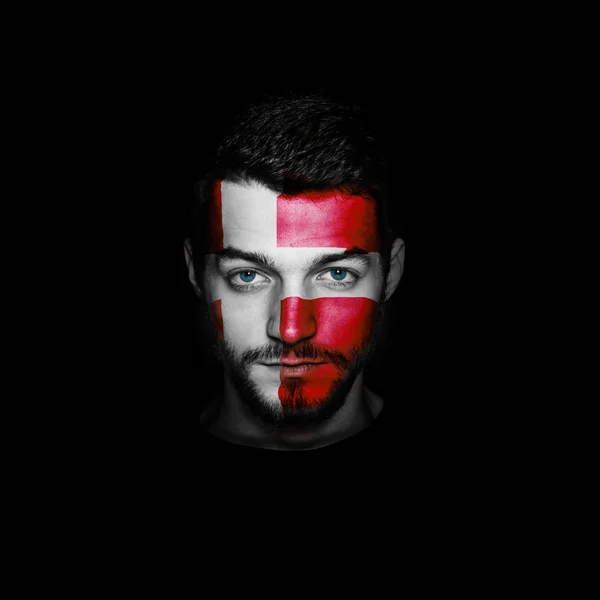 Flag of Denmark painted on a face of a man. — Stock Photo, Image