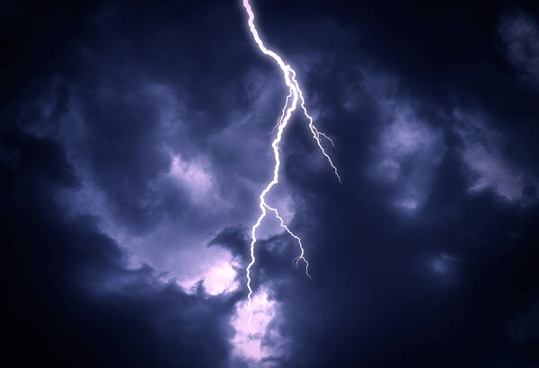 Lightning strike on a cloudy dark sky.
