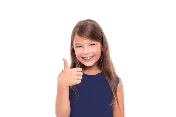 Niña mostrando pulgares hacia arriba sobre fondo blanco . — Foto de Stock