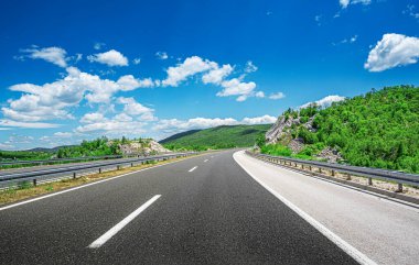 Mountain highway with blue sky. clipart