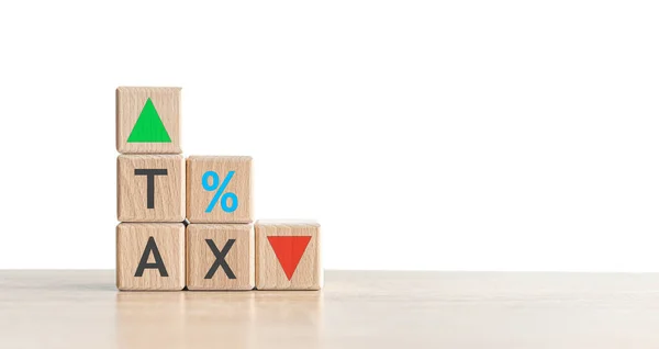 Wooden blocks with the word Tax arrows.