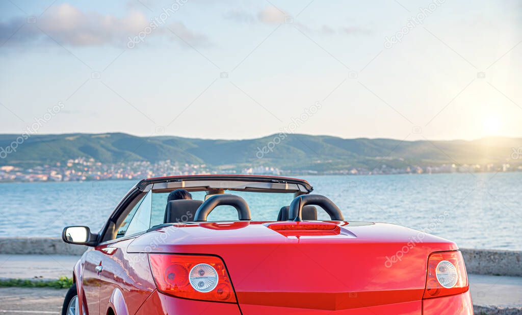 Car on the seashore in the evening.