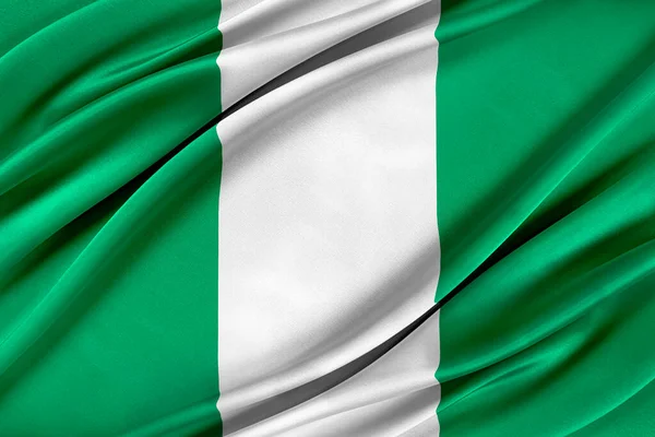 風に揺れるカラフルなナイジェリアの旗. — ストック写真