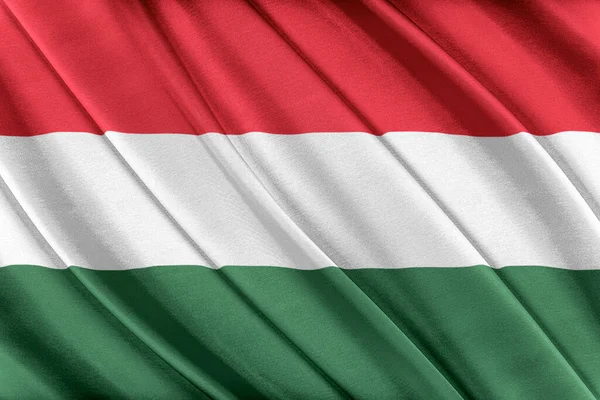 Barevná maďarská vlajka vlající ve větru. — Stock fotografie