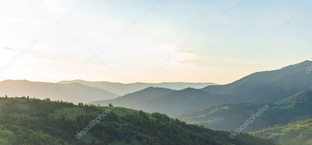 Morning panorama of mountains and forest.