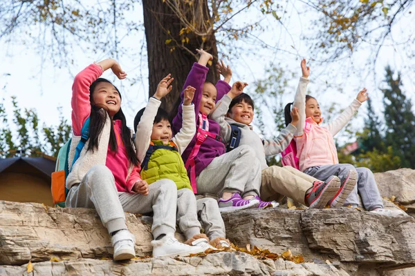 Five Adorable Happy Asian Kids Sitting Stones Hands Autumnal Park — Stock Photo, Image