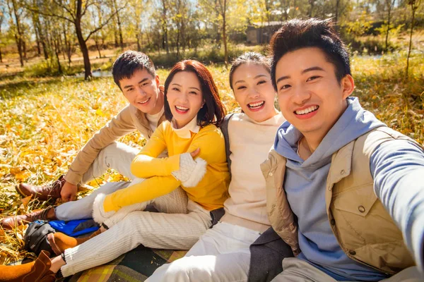 Camera point of view of four young happy asian friends looking at camera in  autumnal forest — couples, togetherness - Stock Photo | #254988744