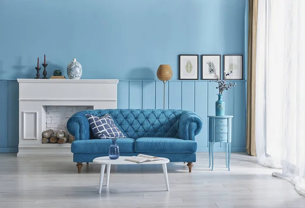 Blue sofa and wall concept, interior decoration with orange lamp, frame middle table style.
