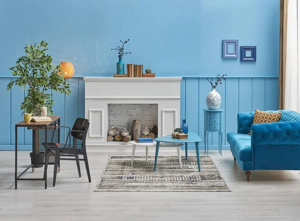 White fireplace in the living room, blue wall interior decoration.