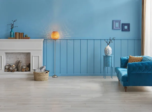 White fireplace in the living room, blue wall interior decoration.