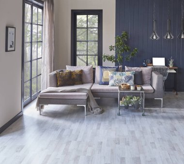 Gri oda kanepe bahçe manzarası ve battaniye.