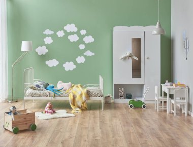 Beyaz dolap, yatak ve yeşil duvar arkaplanı olan çocuk ve bebek odası tarzı, bulanık detay tasarımı.