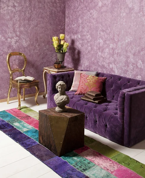 Purple sofa in the room and wallpaper decoration.