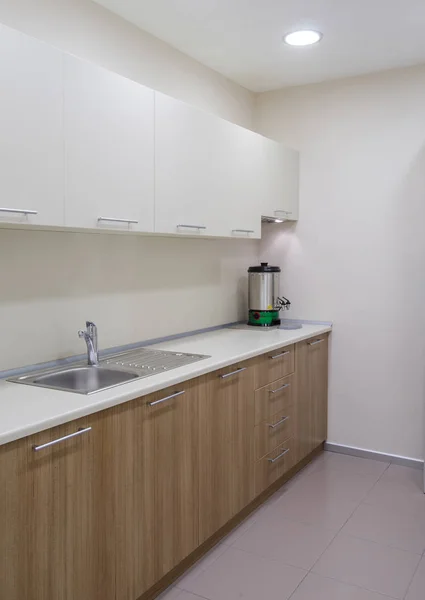 Kitchen cabinet and tub with tea machine.