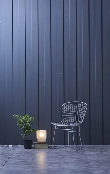 Modern dark blue  wall, textured wall, blue decorative wall,  and green plant in interior concept.