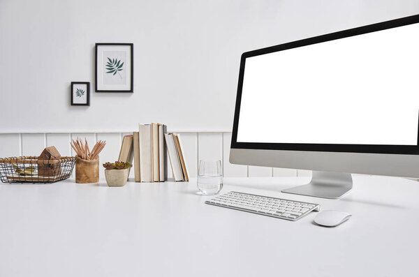 Modern desktop and computer screen isolated on background 