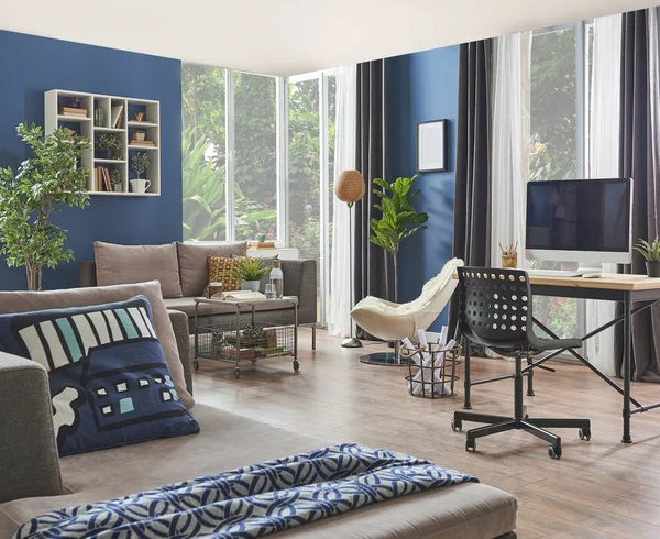 Modern room, blue wall, wooden desk and desktop room corner, sofa, frame carpet and furniture decor with lamp