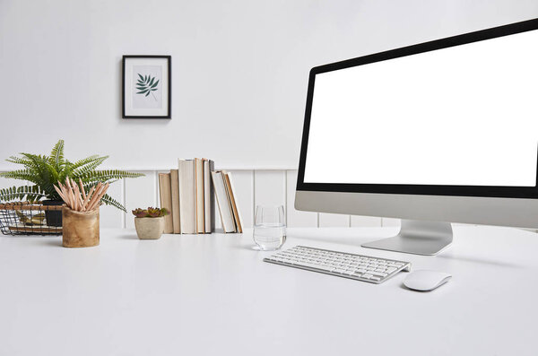 Modern desktop and computer screen isolated on background 