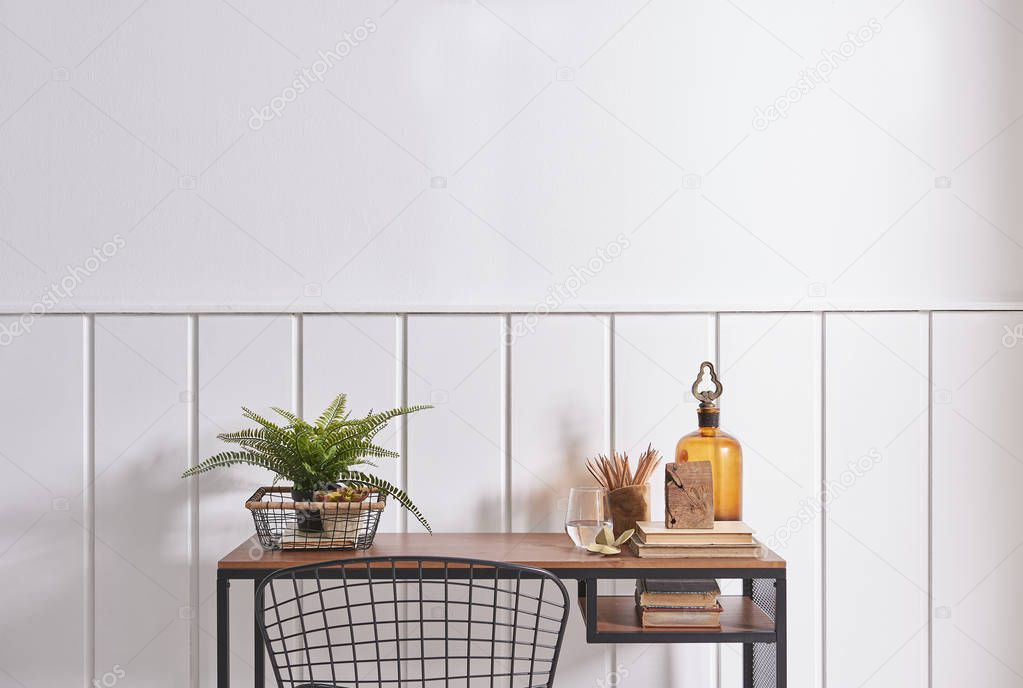 Decorative wooden chair and working table in the white room