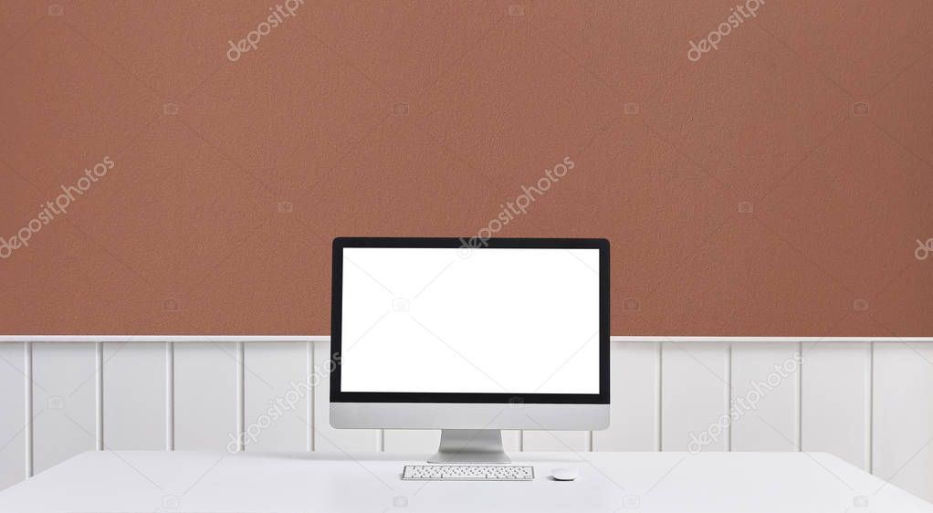 Computer desktop screen and room concept close up style on the table, brick wall white wall and decorative object