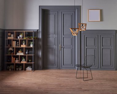 Klasik gri duvar ve kapı tarzında dekoratif ahşap kitaplık, yeşil bitkinin lamba çerçevesi ve vazosu.