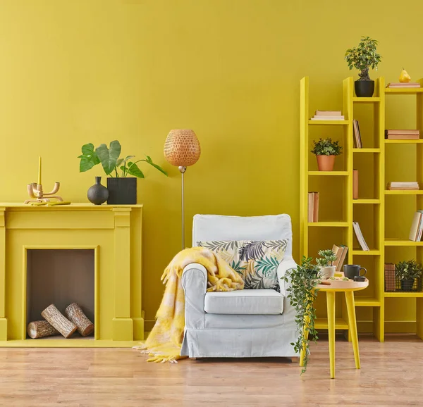 Yellow room interior concept, decorative fireplace wood and candle, bookshelf and home object with lamp, coffee table interior style.