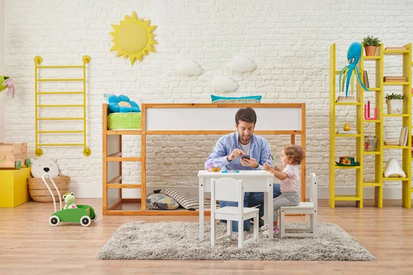Family play baby in the child room, decorative background. Mom and dad interesting interior.Bed, toy and table decor.