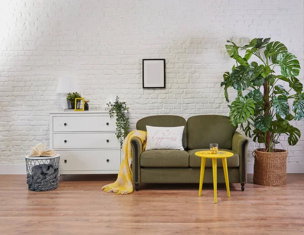 Classic green sofa and yellow coffee table, white cabinet in the room and plant style.