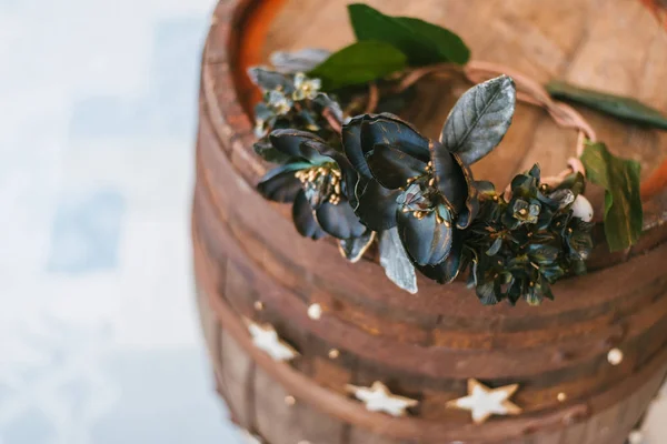 old wooden barrel with flower crown and vintage decoration