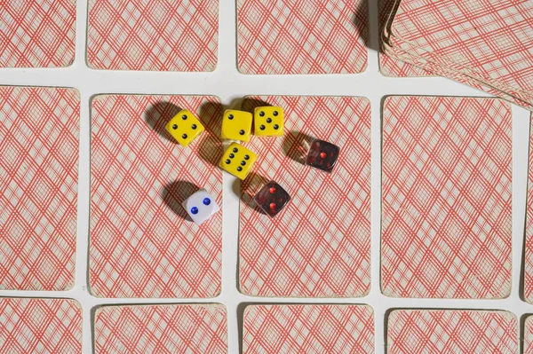Dice and playing cards on white background. Not isolate