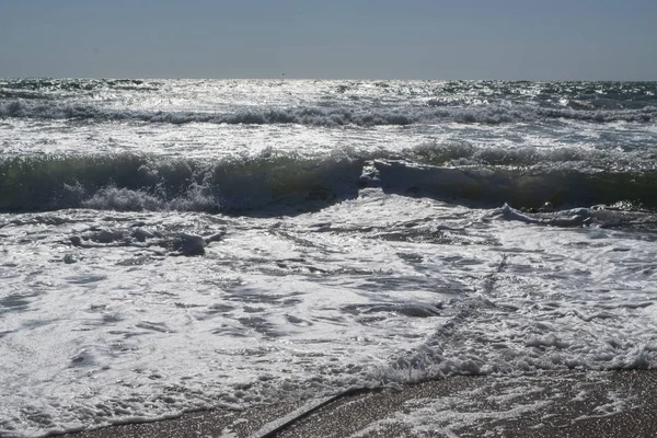 Černé moře. Letní bouře. Na písečné pláži se leskají vlny. — Stock fotografie