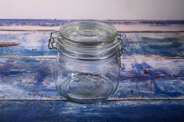 Glass jar with lid and metal lock for storing spices. — Stock Photo, Image