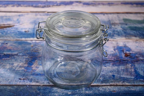 Glass jar with lid and metal lock for storing spices. — Stock Photo, Image