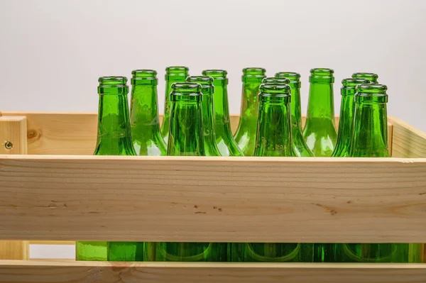 Empty wine bottles in a wooden box on the table. Home winemaking.