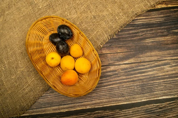 Ripe Apricots Juicy Black Plums Wicker Basket Close Autumn Harvest — Stock Photo, Image