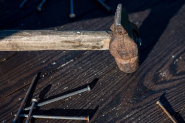 Ahşap arka planda eski model çekiç ve çiviler, yakın plan, seçici odak