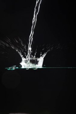 saydam bir cam üzerine düşen su