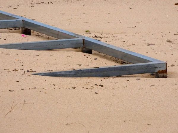 Furniture buried in the sand after a storm