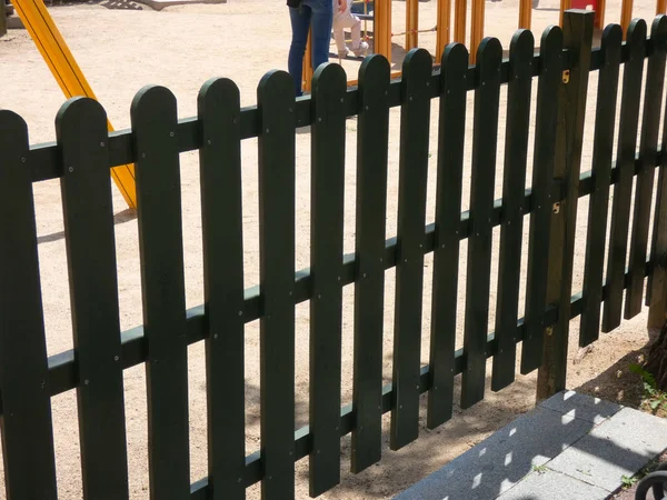 wooden fence that protects the playground, so that children do not leave and to prevent unauthorized people or animals from entering